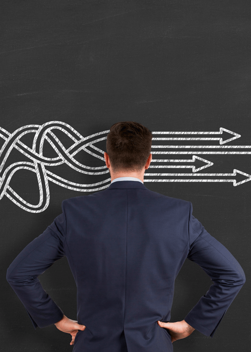 Understanding A man standing in front of a chalkboard with disorganized lines becoming straight as they pass through his head. Representing our communications toolbox.