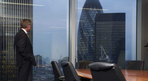 An outlook from a secure organization cybersecurity training for executives represented by Business man in boardroom
